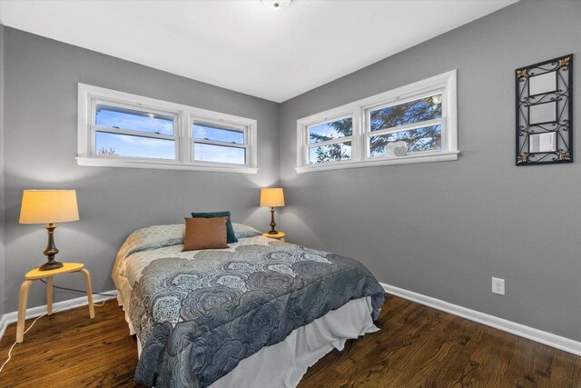 bedroom with dark wood-type flooring