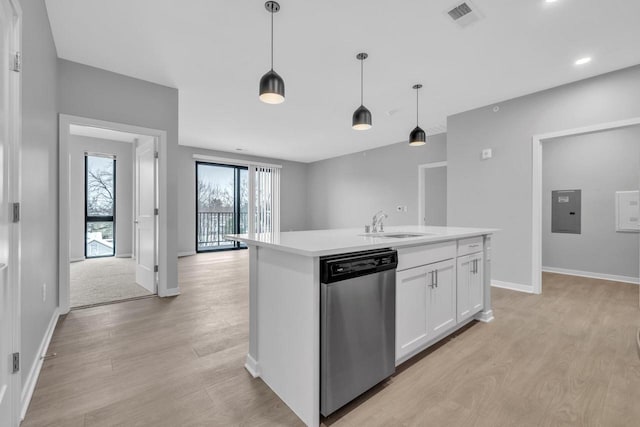 kitchen with light wood-type flooring, stainless steel dishwasher, a center island with sink, white cabinetry, and hanging light fixtures