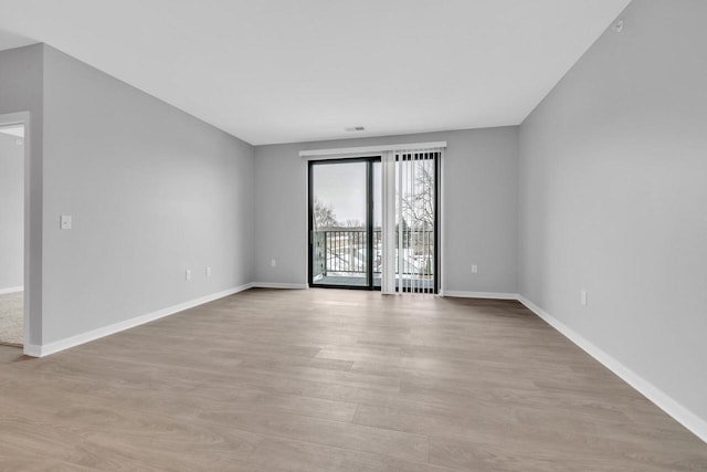 spare room featuring light wood-type flooring