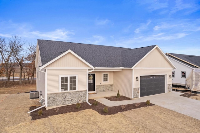 view of front of house featuring central AC unit and a garage