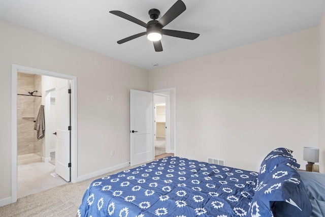 carpeted bedroom featuring ensuite bath and ceiling fan