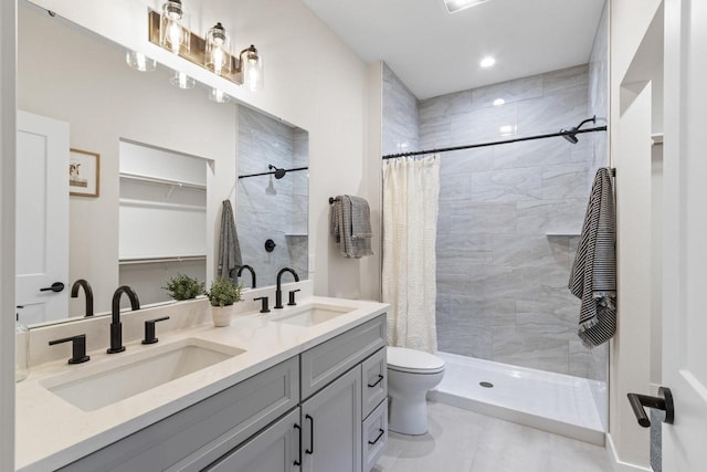 bathroom featuring tile patterned flooring, vanity, curtained shower, and toilet