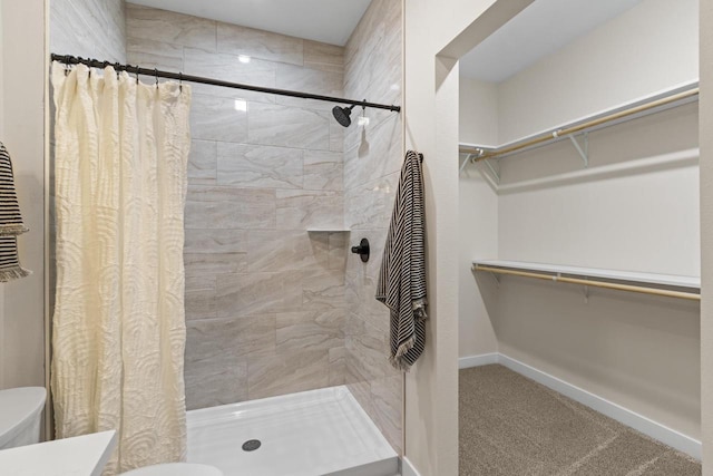 bathroom with toilet and walk in shower