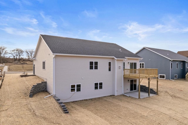 rear view of house featuring a patio area and a wooden deck