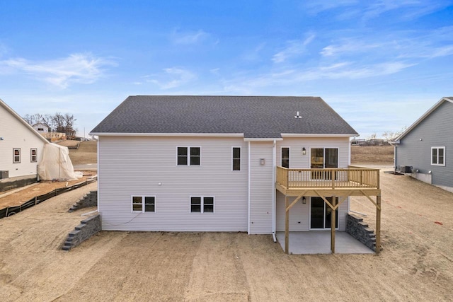 rear view of property featuring a patio area and a wooden deck