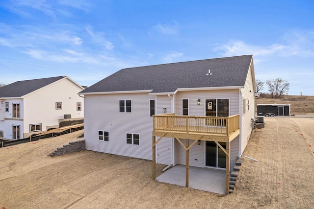 back of property with a patio area and a wooden deck