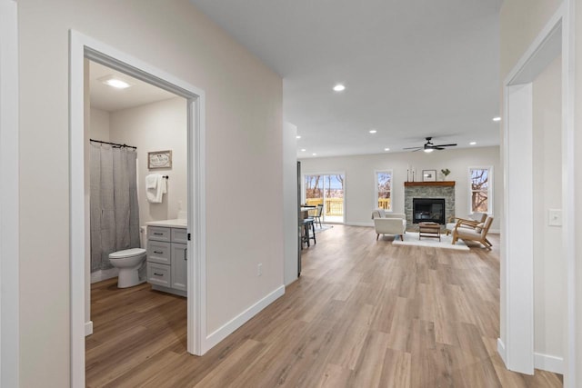 hallway with light hardwood / wood-style floors