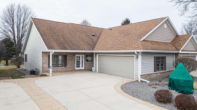 view of front of property with central AC and a garage