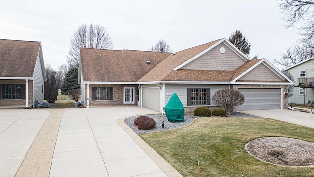 view of front of home with a garage and a front lawn