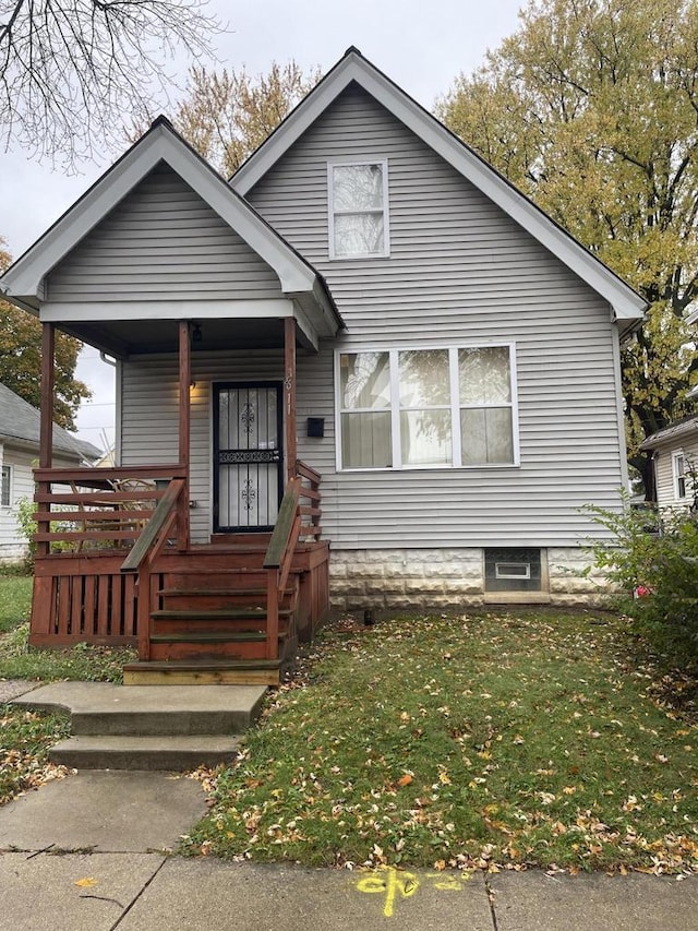 bungalow-style home with a front lawn