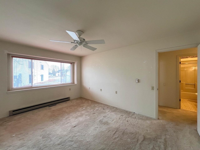 carpeted spare room with ceiling fan and a baseboard radiator