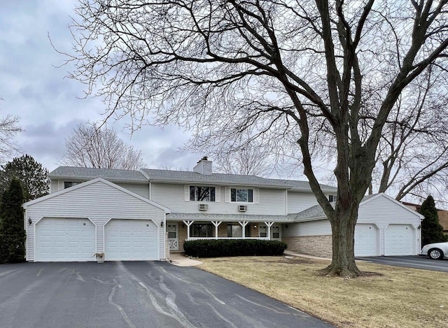 view of front of house with a garage and a front lawn