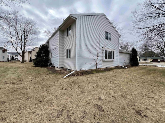 view of side of home featuring a yard