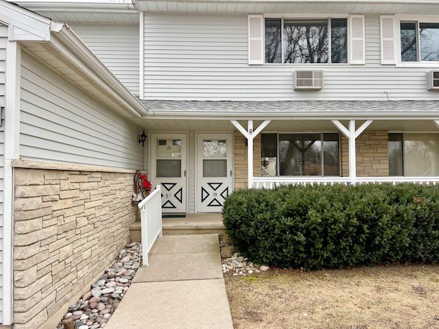 entrance to property featuring a wall mounted AC