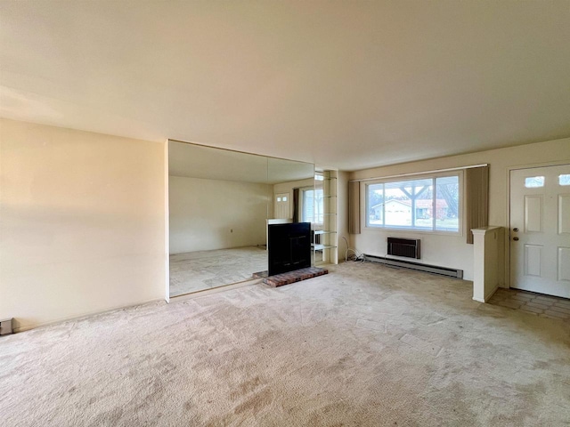 unfurnished living room featuring carpet floors and baseboard heating