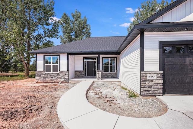 entrance to property with a garage and covered porch