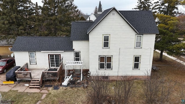 back of property with a wooden deck