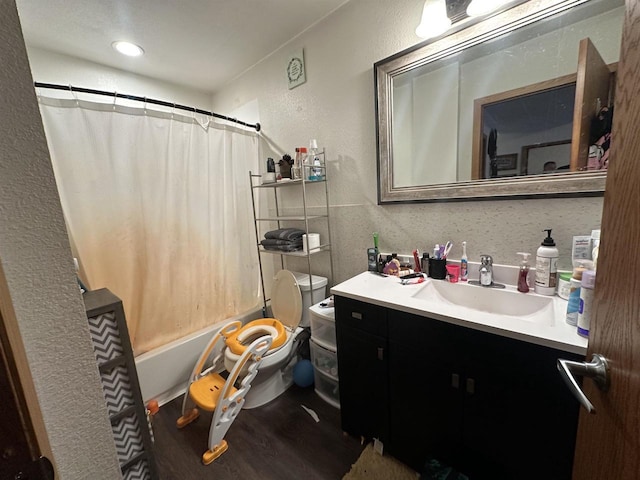 bathroom featuring wood-type flooring, vanity, and toilet