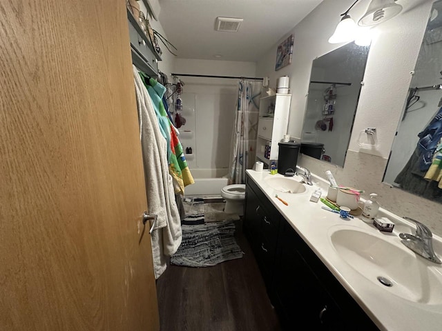 full bathroom with wood-type flooring, vanity, toilet, and shower / bathtub combination with curtain