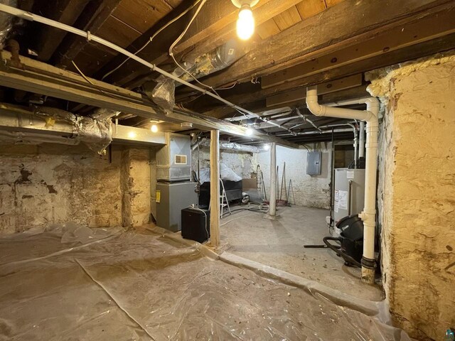 115 8th St E, Ashland, WI 54806 - unfinished below grade area featuring water heater, visible vents, electric panel, and heating unit