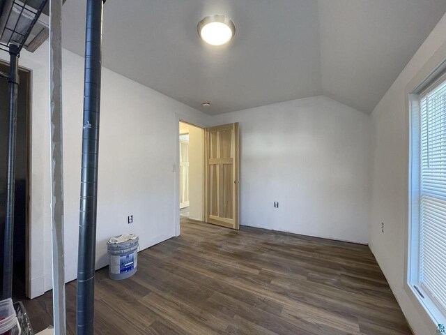 115 8th St E, Ashland, WI 54806 - unfurnished bedroom with vaulted ceiling and dark wood-type flooring