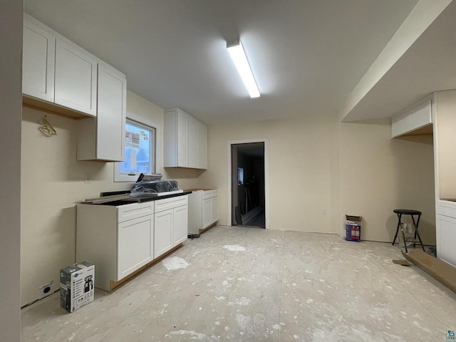 115 8th St E, Ashland, WI 54806 - kitchen with dark countertops and white cabinets