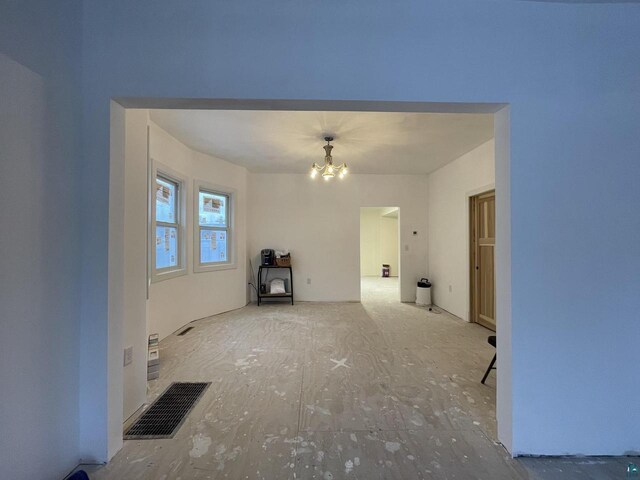 115 8th St E, Ashland, WI 54806 - unfurnished living room with visible vents and a chandelier