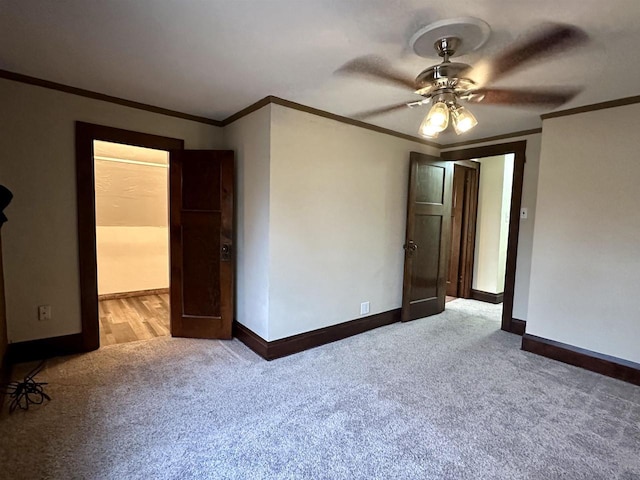 unfurnished bedroom featuring ceiling fan, light colored carpet, and ornamental molding