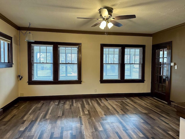 unfurnished room with ceiling fan, dark hardwood / wood-style flooring, a textured ceiling, and ornamental molding