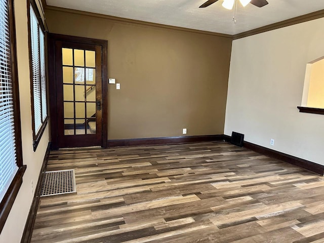 spare room with hardwood / wood-style floors, ceiling fan, and ornamental molding