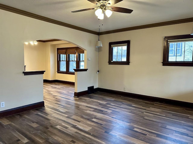 unfurnished room with dark hardwood / wood-style floors, plenty of natural light, and crown molding