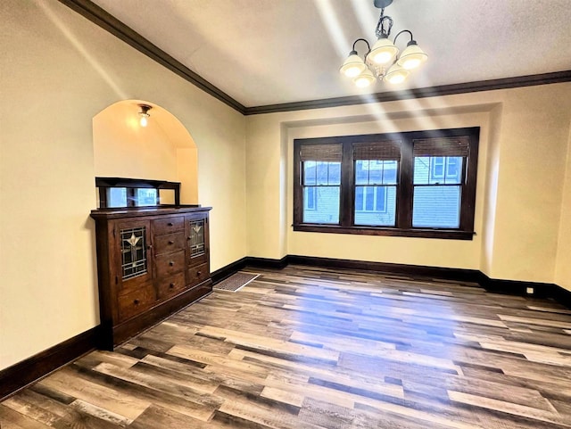 dining space featuring a chandelier, hardwood / wood-style floors, and crown molding