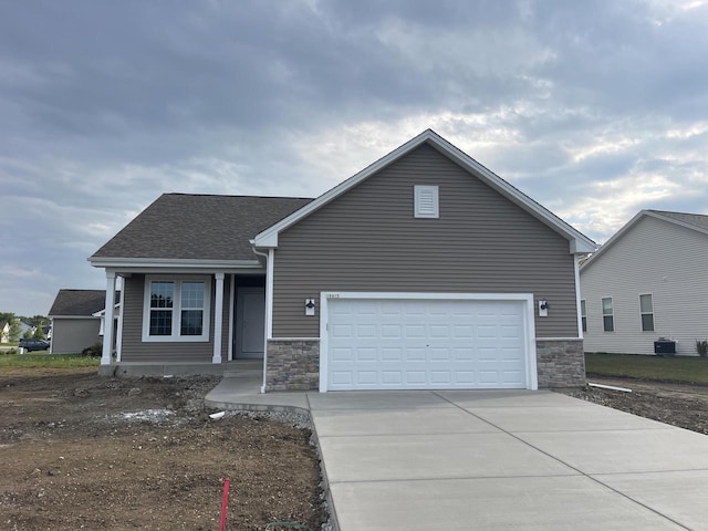 view of front of house with a garage and central AC