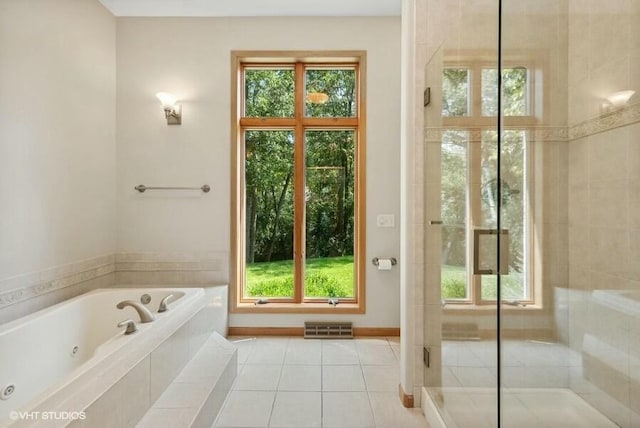 bathroom with tile patterned flooring and separate shower and tub