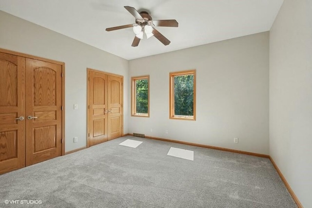 unfurnished bedroom featuring ceiling fan and carpet flooring