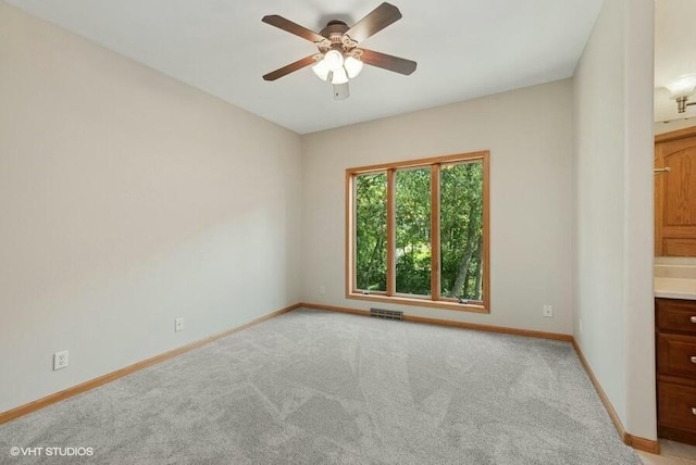 carpeted empty room featuring ceiling fan