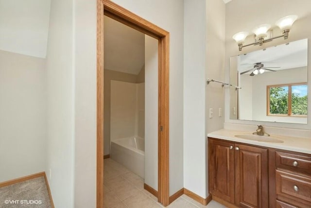 bathroom featuring ceiling fan, vanity, tile patterned flooring, and a bathtub