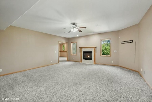 unfurnished living room with ceiling fan and light carpet