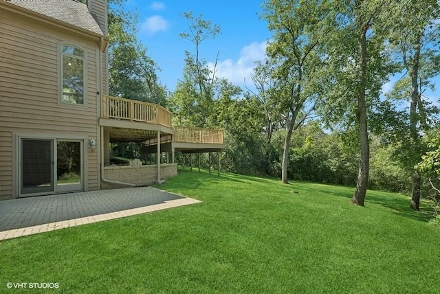 view of yard with a wooden deck and a patio