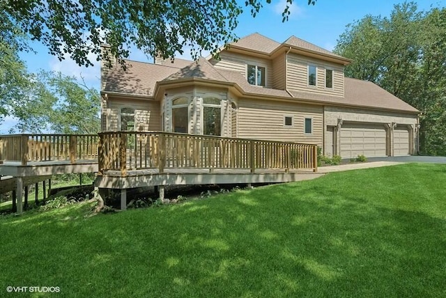 back of property featuring a wooden deck, a garage, and a yard