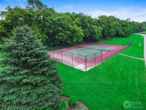 view of sport court featuring a lawn