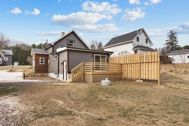 rear view of property with a wooden deck