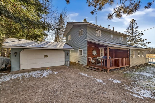 rear view of property with a garage