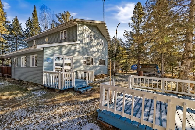 snow covered property featuring a wooden deck