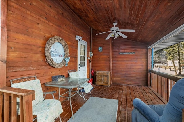 sunroom with lofted ceiling, ceiling fan, and wood ceiling