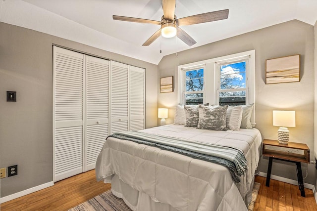 bedroom featuring a closet, vaulted ceiling, ceiling fan, and light hardwood / wood-style floors