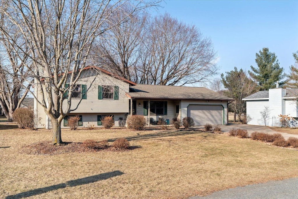 split level home featuring a front lawn and a garage