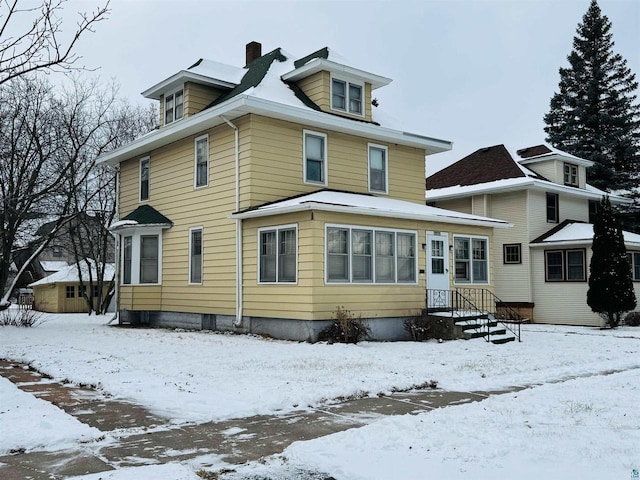 view of snow covered house