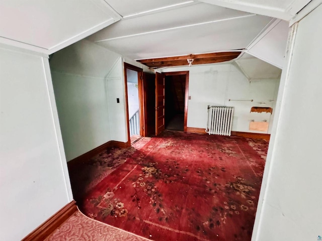 bonus room featuring radiator heating unit and vaulted ceiling