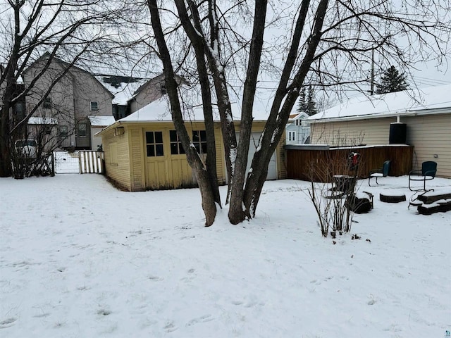 view of snow covered back of property